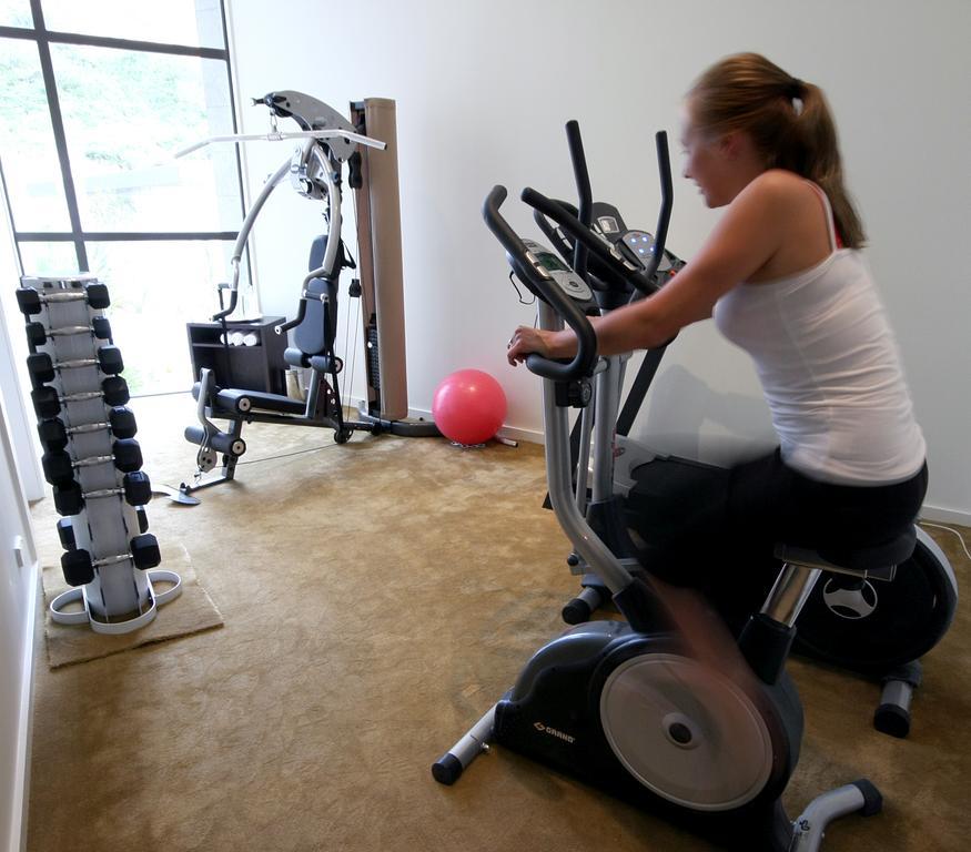 Braemar Lodge And Spa Hanmer Springs Exterior photo A woman on a stationary bicycle